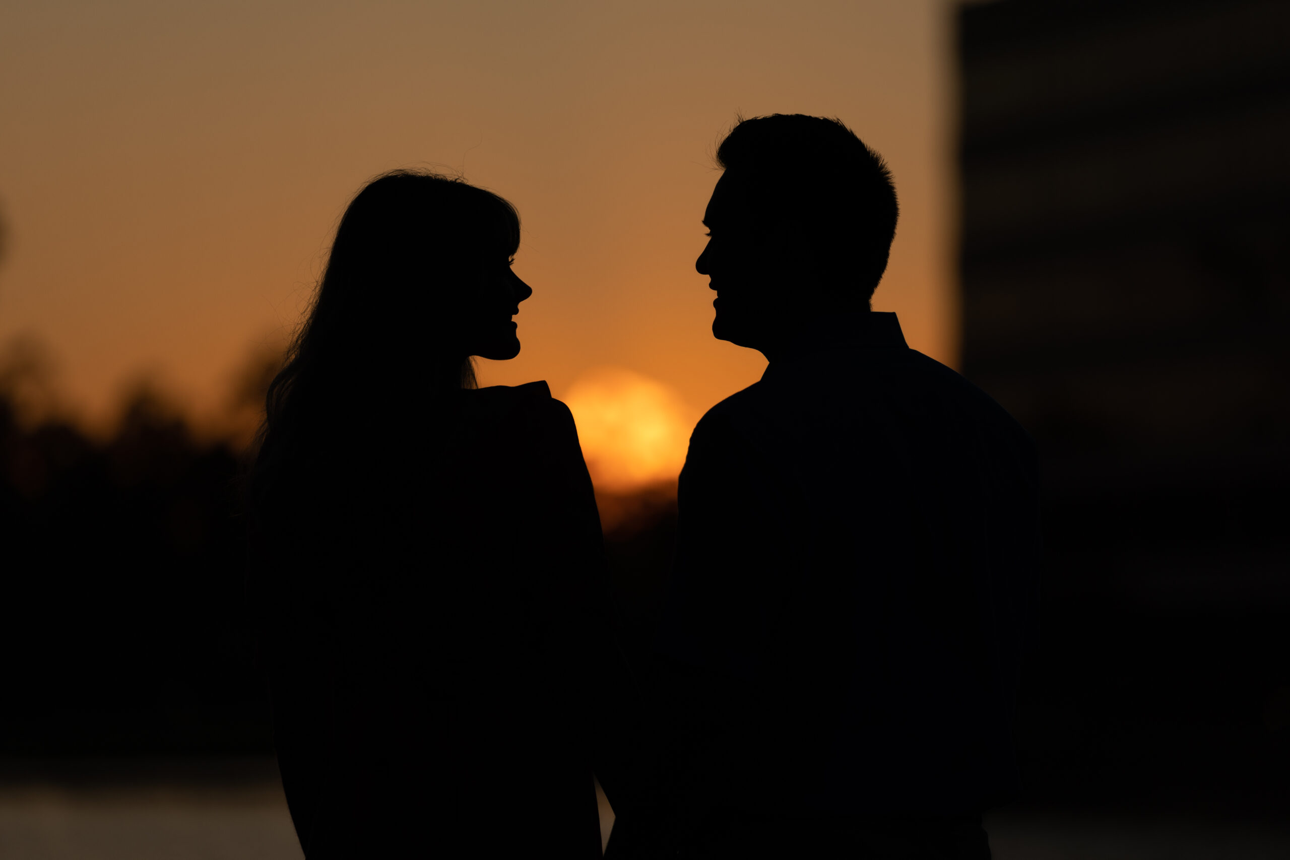 Silhouette of couple during sunset, facing each other